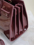 Sac De Jour burgundy patent leather handbag